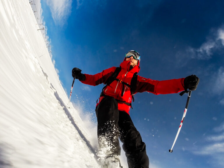 Skier performs a high speed turn on a ski slope